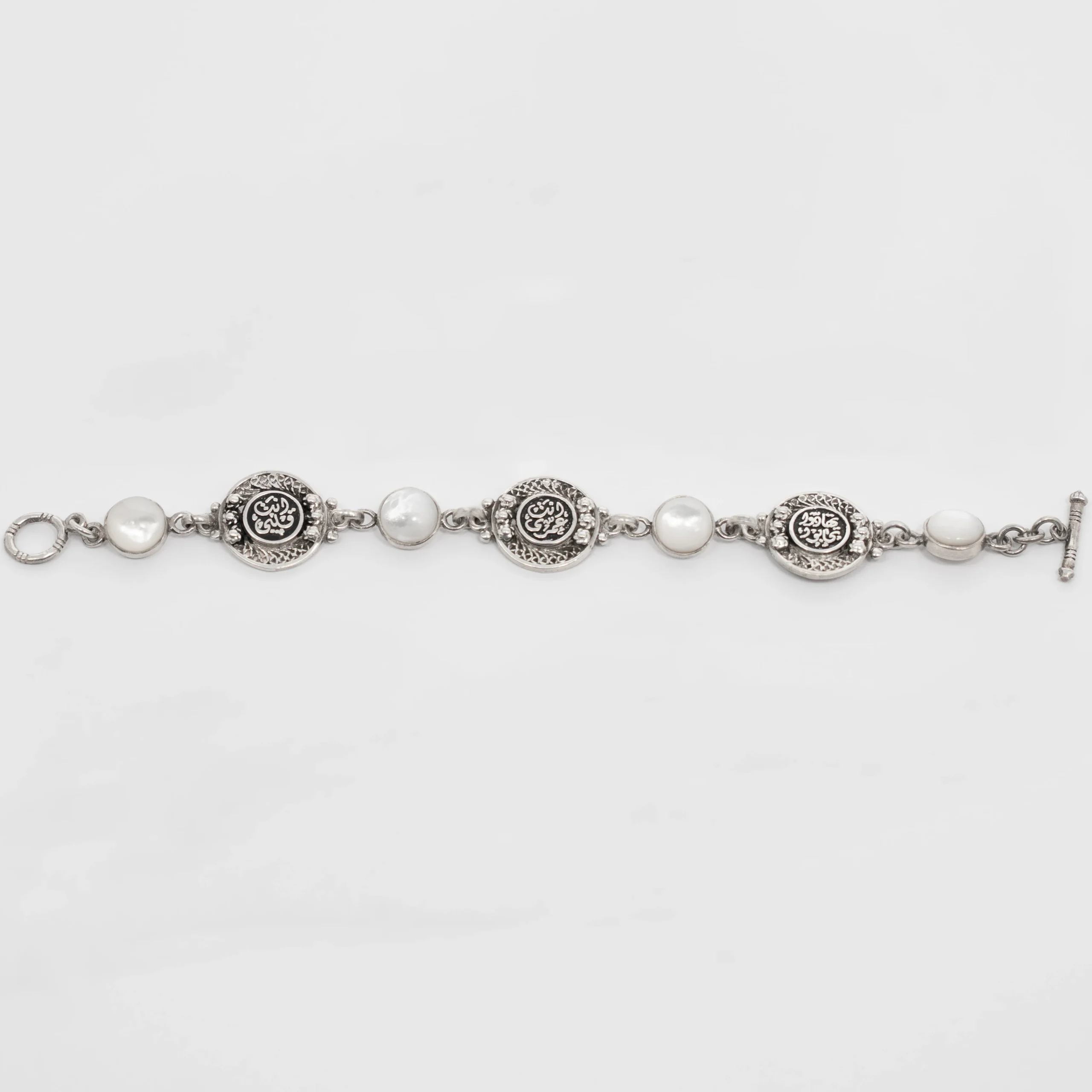 Silver Bracelet with White Mother of Pearl and Engraved Coin Charms - Image 2