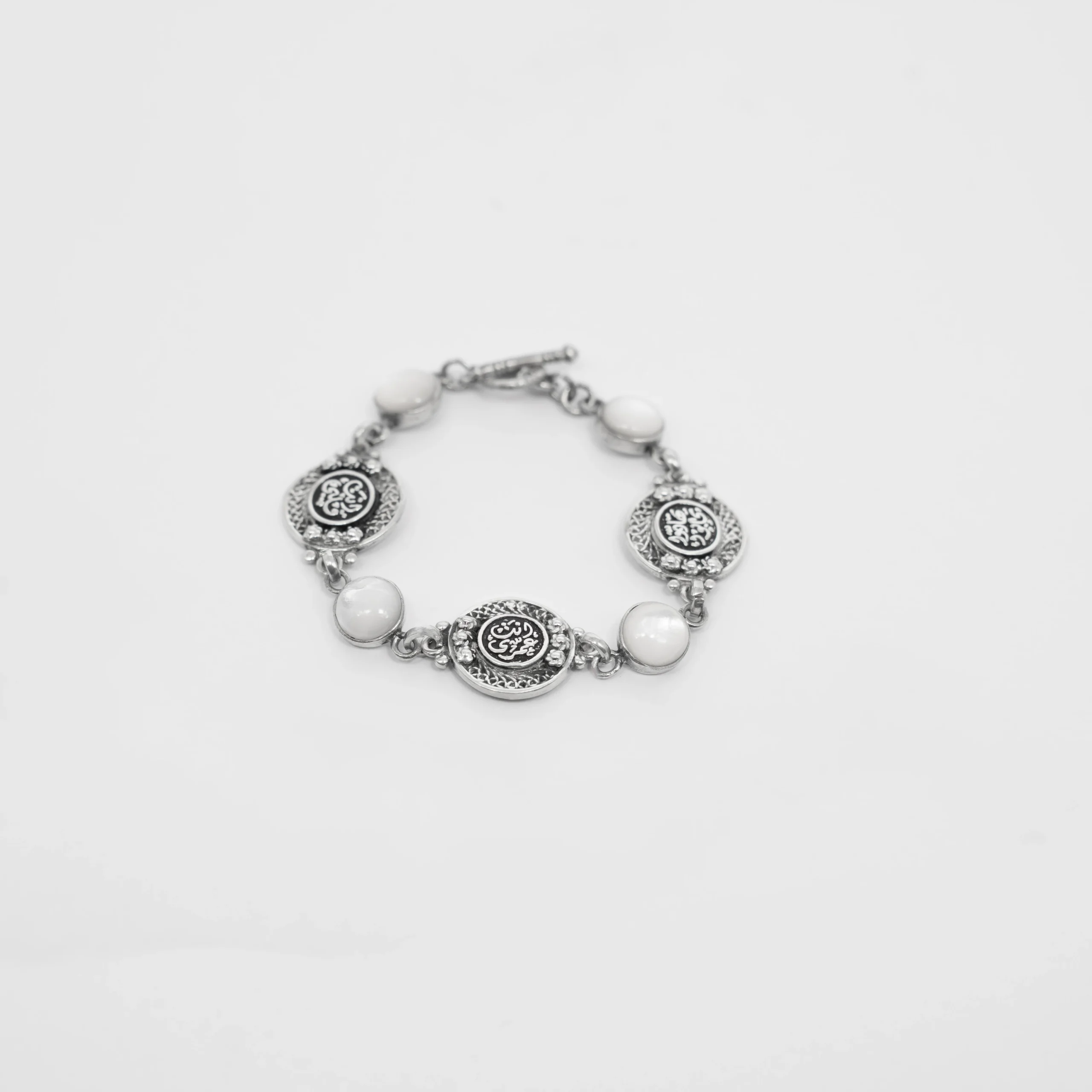 Silver Bracelet with White Mother of Pearl and Engraved Coin Charms - Image 4