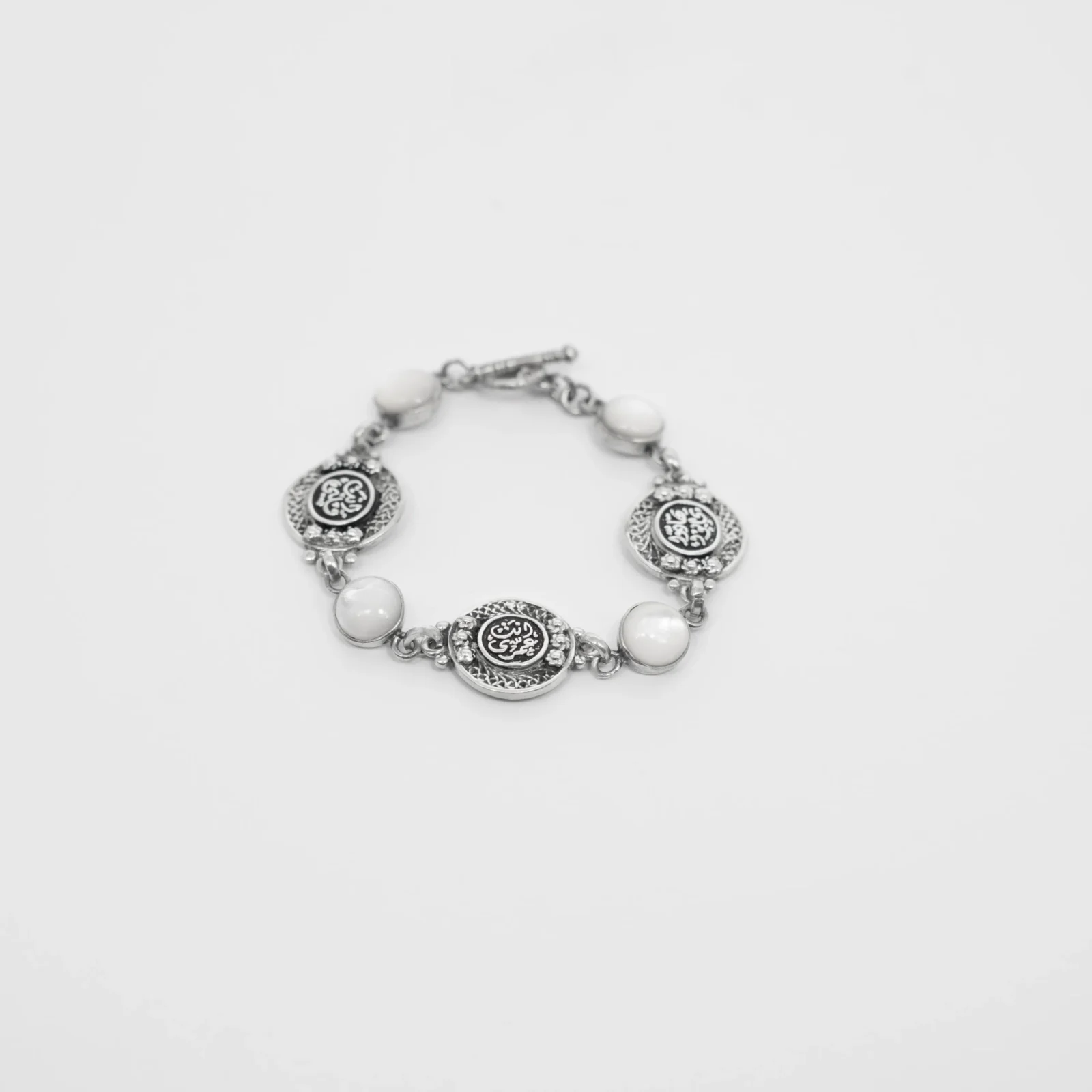 Silver Bracelet with White Mother of Pearl and Engraved Coin Charms