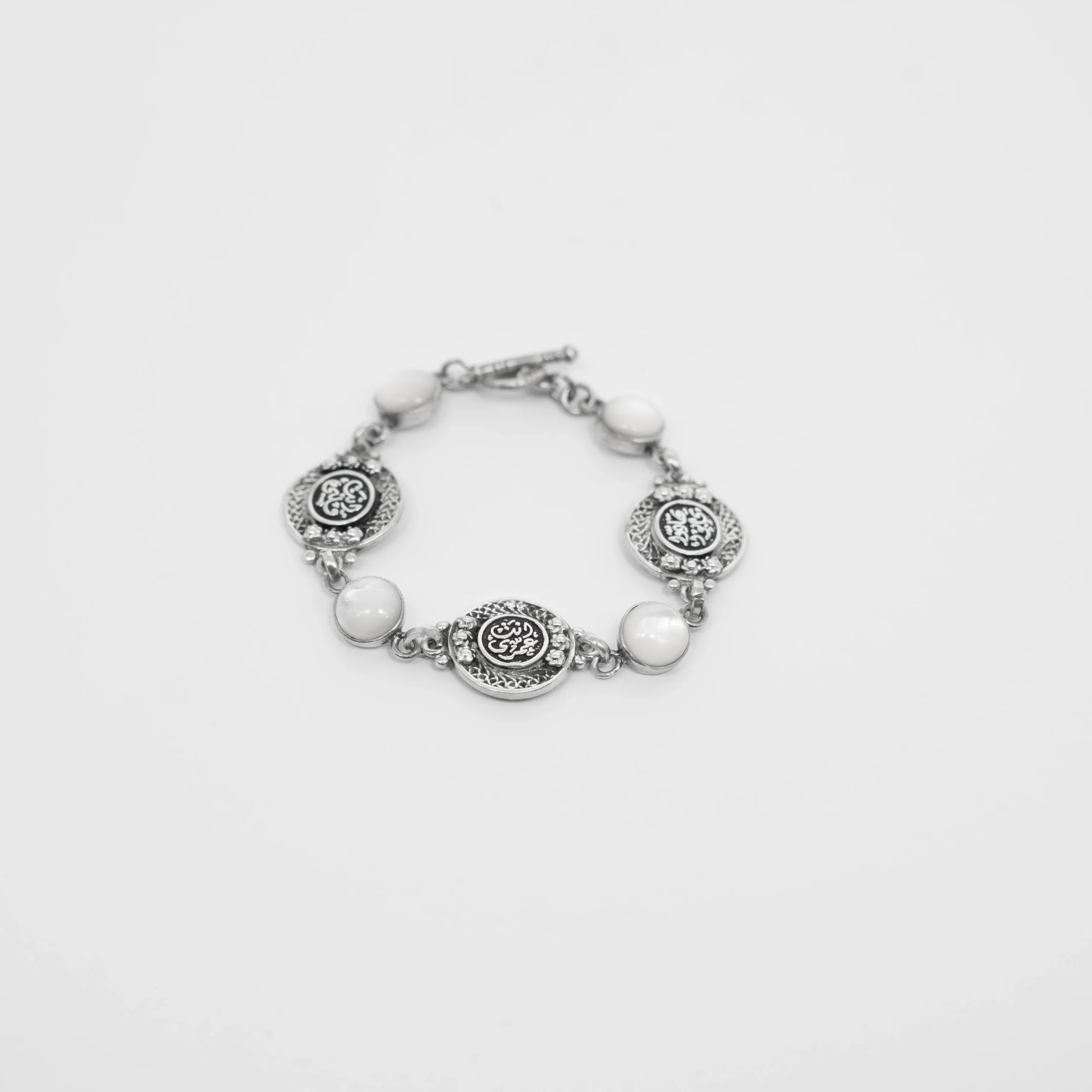 Silver Bracelet with White Mother of Pearl and Engraved Coin Charms